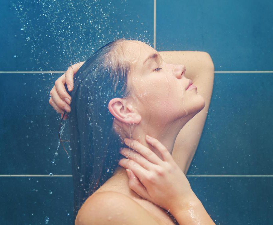 woman taking a steaming, hot shower